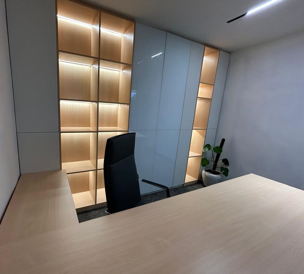 Executive cabin with backlit shelving and a glazed partition
