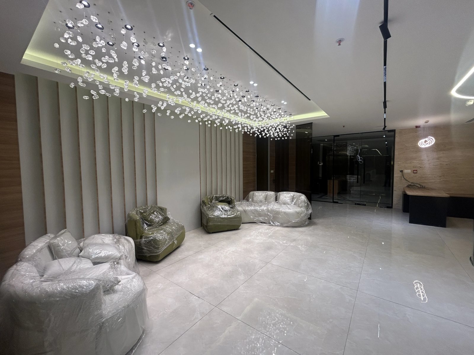 Office reception with a sculpted crystal-glass ceiling feature