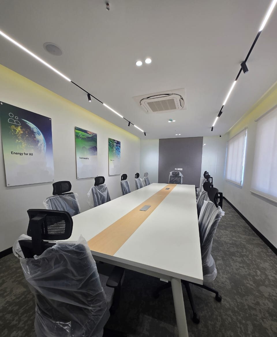 Glass-walled meeting room with a marble-effect table